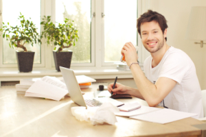Confident Smiling Man Working At Desk